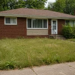 brick ranch house in Michigan with slightly overgrown grass during probate